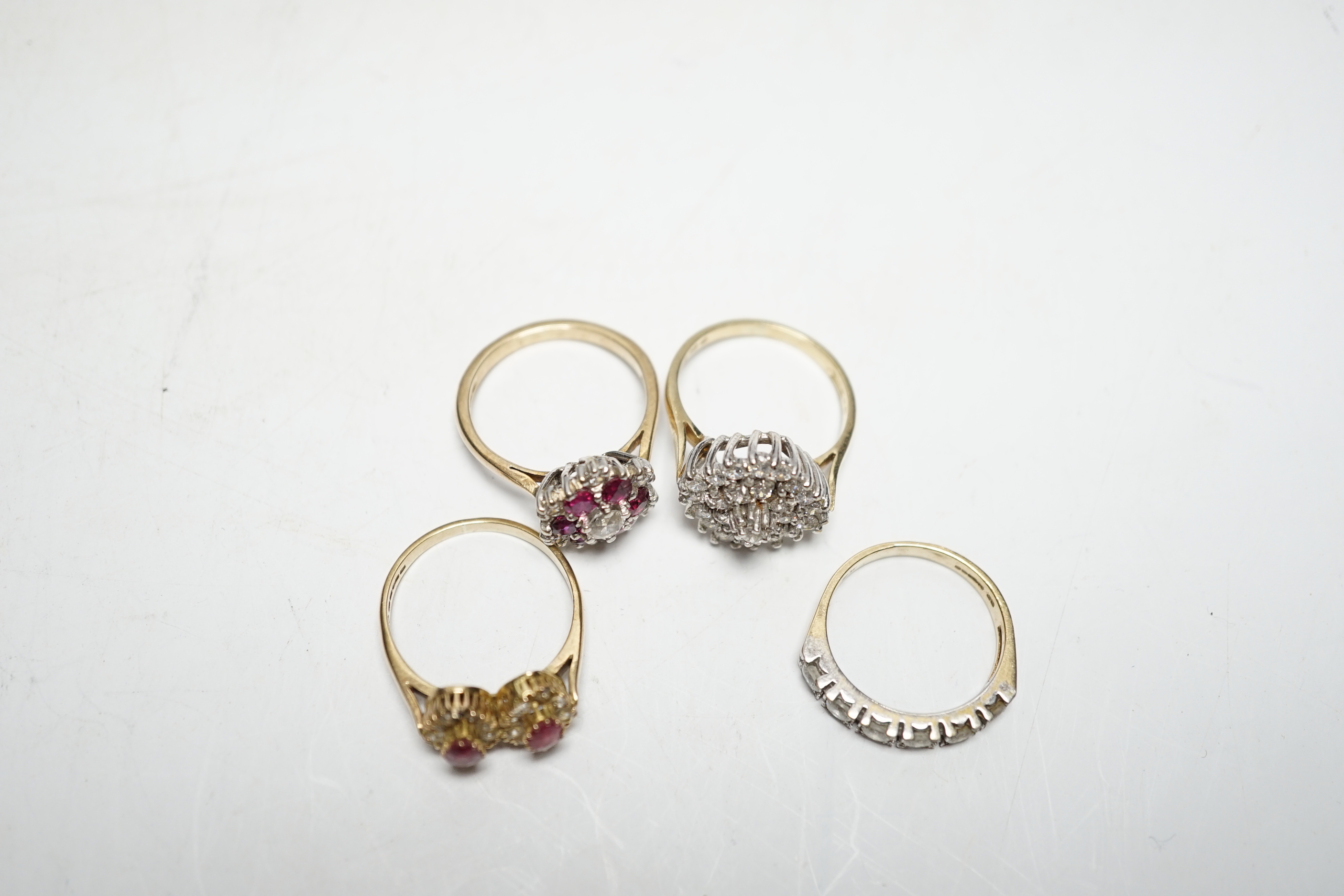 A modern 9ct gold, ruby and simulated diamond cluster set flower head ring, size N and three other assorted 9ct rings including CZ and two colour paste, gross weight 12.4 grams.